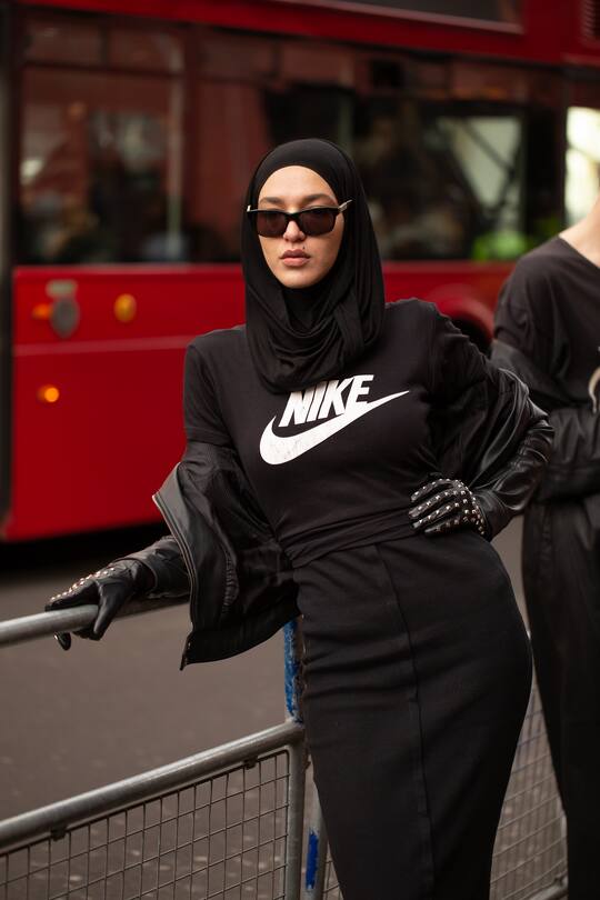 LONDON, ENGLAND - FEBRUARY 19: A guest is seen on the street during London Fashion Week February 2019 wearing black jacket and hijab with Nike black shirt and skirt on February 19, 2019 in London, England. (Photo by Matthew Sperzel/Getty Images)