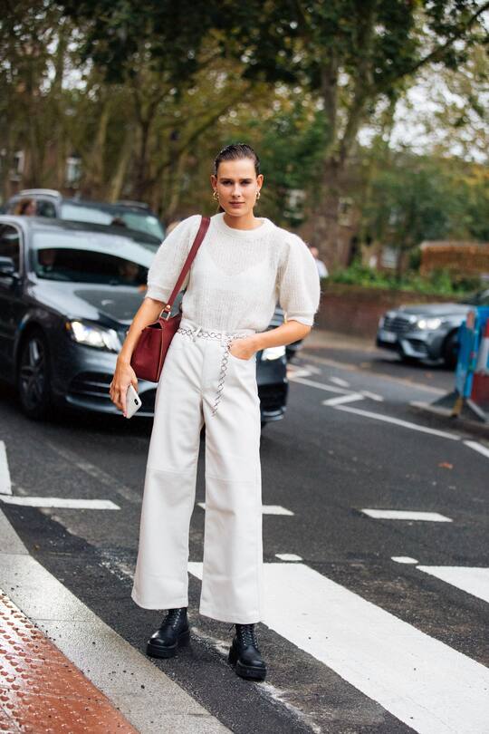 LONDON, ENGLAND - SEPTEMBER 16: Model Vera Van Erp wears a white cashmere Getuz top, white flare jeans, and black boots at the Christopher Kane show during London Fashion Week September 2019 on September 16, 2019 in London, England. (Photo by Melodie Jeng/Getty Images)