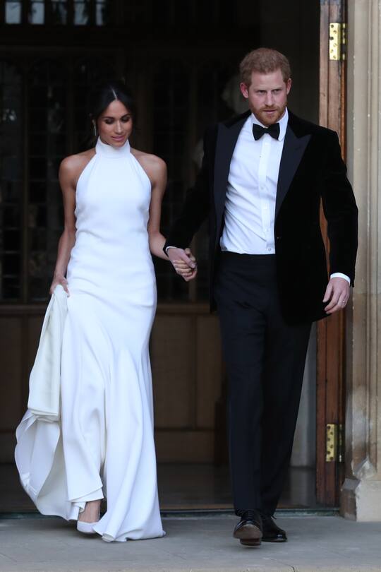 WINDSOR, UNITED KINGDOM - MAY 19: Duchess of Sussex and Prince Harry, Duke of Sussex leave Windsor Castle after their wedding to attend an evening reception at Frogmore House, hosted by the Prince of Wales on May 19, 2018 in Windsor, England. (Photo by Steve Parsons - WPA Pool/Getty Images)
