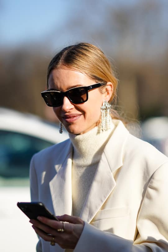 PARIS, FRANCE - JANUARY 21: Pernille Teisbaek wears Chanel sunglasses, earrings, rings, a fluffy cream-color turtleneck, a white jacket, outside Chanel, during Paris Fashion Week - Haute Couture Spring/Summer 2020, on January 21, 2020 in Paris, France. (Photo by Edward Berthelot/Getty Images )