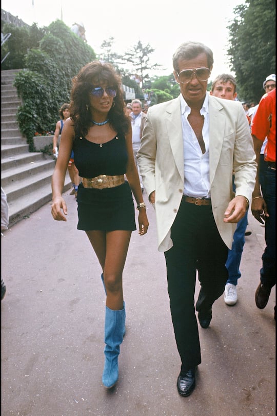 Jean-Paul Belmondo and girlfriend Carlos Sotto Mayor at Roland Garros, 1982. (Photo by Bertrand Rindoff Petroff/Getty Images)