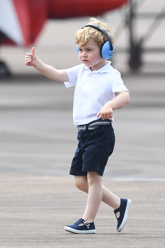 FAIRFORD, ENGLAND - JULY 08: Prince George of Cambridge gives a thumbs up as he attends the The Royal International Air Tattoo at RAF Fairford on July 8, 2016 in Fairford, England. (Photo by Samir Hussein/WireImage)