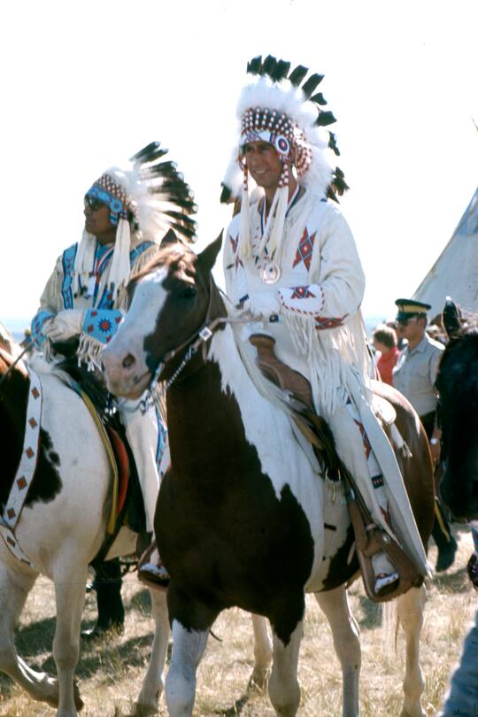 CANADA - JULY 6: Prince Charles dressed in an Indian headdress opens the Calgary Stampede on July 6, 1977 in Calgary, Alberta, Canada . (Photo by Paul Harris/Getty Images)