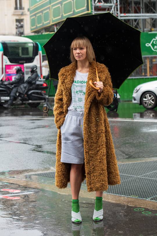 PARIS, FRANCE - MARCH 02: Fashion designer Vika Gazinskaya wears Gucci shoes, Radiohead T shirt, green socks, grey shorts and a Vika Gazinskaya coat on March 02, 2020 in Paris, France. (Photo by Kirstin Sinclair/Getty Images)