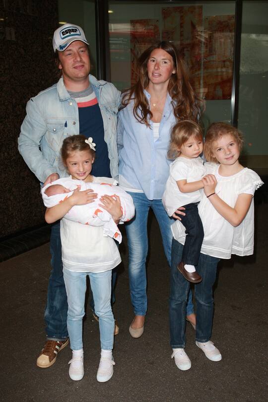 LONDON, UNITED KINGDOM - SEPTEMBER 16: Jamie Oliver and wife Jools Oliver, with daughters poppy Honey, Daisy Boo and Blossom Rainbow, leave Portland Hospital with their newborn baby son Buddy on September 16, 2010 in London, England. (Photo by Neil Mockford/FilmMagic)