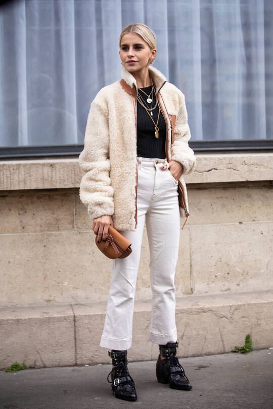 PARIS, FRANCE - MARCH 01: Caroline Daur, wearing a fur jacket, white jeans, black boots and tan Loewe bag, is seen outside Nina Ricci on Day 5 Paris Fashion Week Autumn/Winter 2019/20 on March 1, 2019 in Paris, France. (Photo by Claudio Lavenia/Getty Images)