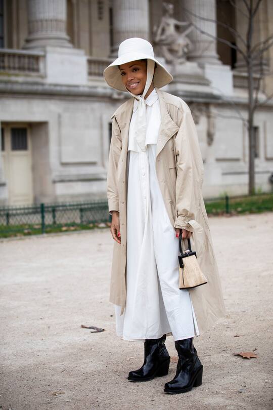 PARIS, FRANCE - FEBRUARY 27: Erika Boldrin (R) wears a turtleneck, a grey jacket with apparent white seams, a purple puff bag ; Blanca Miro (L) wears a black hat, a grey sleeveless vest, grey pants, a red puff bag, outside Maison Margiela, during Paris Fashion Week Womenswear Fall/Winter 2019/2020, on February 27, 2019 in Paris, France. (Photo by Edward Berthelot/Getty Images)