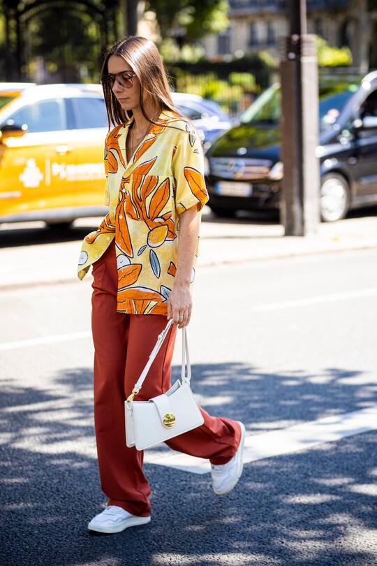 PARIS, FRANCE - JUNE 21: Alice Barbier, wearing a colorful printed shirt, orange pants, white bag and white sneakers, is seen outside Ann Demeulemeester fashion show on Day 4 during the Paris Fashion Week Spring/Summer 2020 on June 21, 2019 in Paris, France. (Photo by Claudio Lavenia/Getty Images)