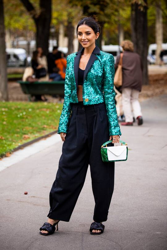 PARIS, FRANCE - SEPTEMBER 28: Nathalie Fanj, wearing a teal blue sequins blazer, black striped pants and black Bottega Veneta sandals, is seen outside the Elie Saab show during Paris Fashion Week - Womenswear Spring Summer 2020 on September 28, 2019 in Paris, France. (Photo by Claudio Lavenia/Getty Images)