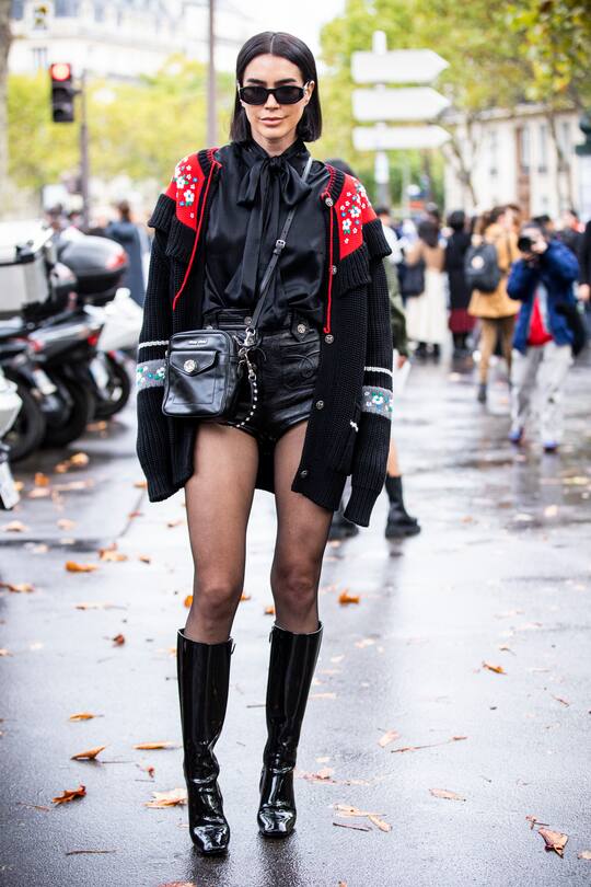PARIS, FRANCE - OCTOBER 01: Brittany Xavier, wearing a black blouse, black decorated cardigan, black leather shorts, black Miu miu bag and black boots, is seen outside the Miu Miu show during Paris Fashion Week - Womenswear Spring Summer 2020 on October 01, 2019 in Paris, France. (Photo by Claudio Lavenia/Getty Images)