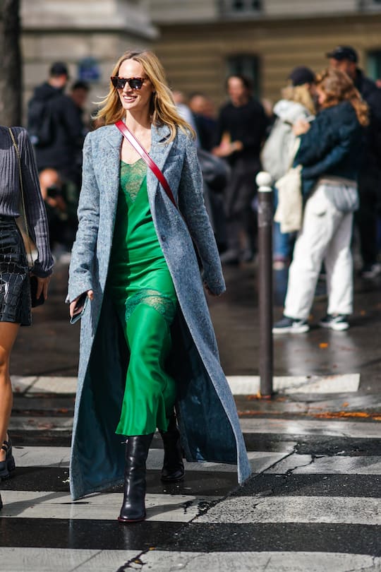 PARIS, FRANCE - OCTOBER 01: Lauren Santo Domingo wears sunglasses, a long light blue wool coat, a green dress with a green lace yoke and a green lace insert a the thighs, black boots , outside Miu Miu, during Paris Fashion Week - Womenswear Spring Summer 2020, on October 01, 2019 in Paris, France. (Photo by Edward Berthelot/Getty Images)