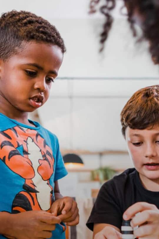 two kids looking on the ground