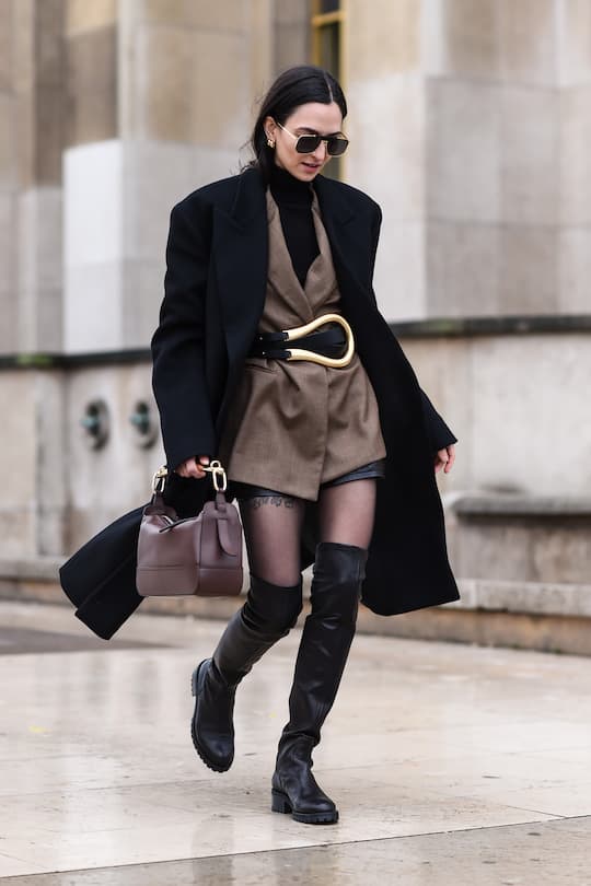 PARIS, FRANCE - FEBRUARY 27: A guest is seen wearing a black coat, brown jacket, black boots and brown bag outside the Ann Demeulemeester show during Paris Fashion Week: AW20 on February 27, 2020 in Paris, France. (Photo by Daniel Zuchnik/Getty Images)