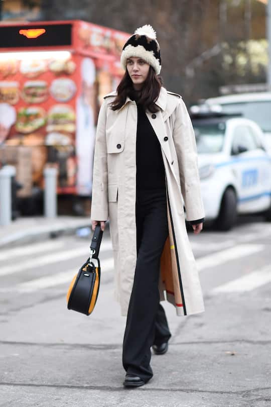 NEW YORK, NEW YORK - FEBRUARY 11: A guest is seen wearing a cream coat, Proenza Schouler bag and fur beanie outside the Proenza Schouler show during New York Fashion Week: Fall/Winter 2019 on February 11, 2019 in New York City. (Photo by Daniel Zuchnik/Getty Images)