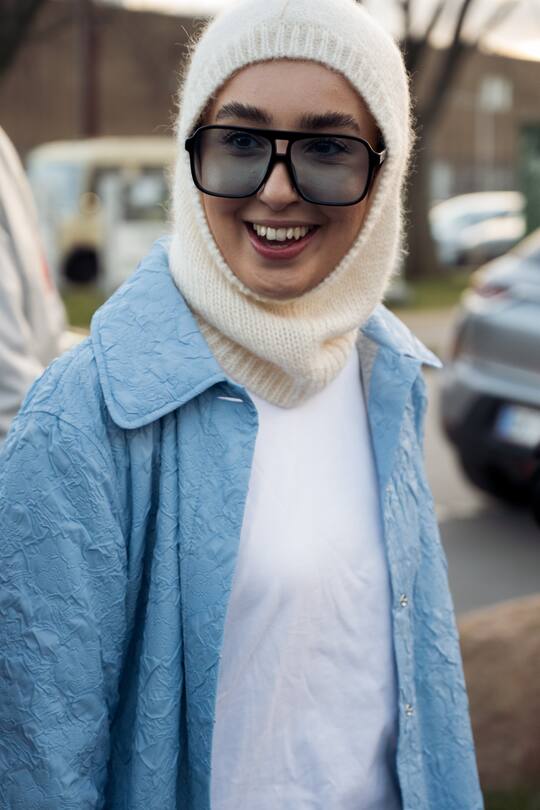 COPENHAGEN, DENMARK - FEBRUARY 02: Guest wearing knitted skiing mask, white T-shirt and blue shirt and outside Soulland in Copenhagen fashion week Autumn/Winter 2022 on February 02, 2022 in Copenhagen, Denmark. (Photo by Raimonda Kulikauskiene/Getty Images)