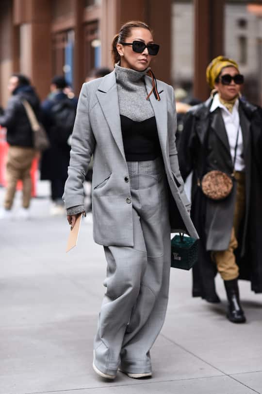 NEW YORK, NEW YORK - FEBRUARY 12: A guest is seen wearing a gray Michael Kors outfit with black sunglasses outside the Michael Kors show during New York Fashion Week: A/W20 on February 12, 2020 in New York City. (Photo by Daniel Zuchnik/Getty Images)