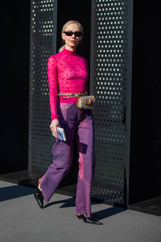 MILAN, ITALY - FEBRUARY 25: Olga Karput is seen wearing pink top, purple pants, Gucci bag outside Gucci fashion show during the Milan Fashion Week Fall/Winter 2022/2023 on February 25, 2022 in Milan, Italy. (Photo by Christian Vierig/Getty Images)