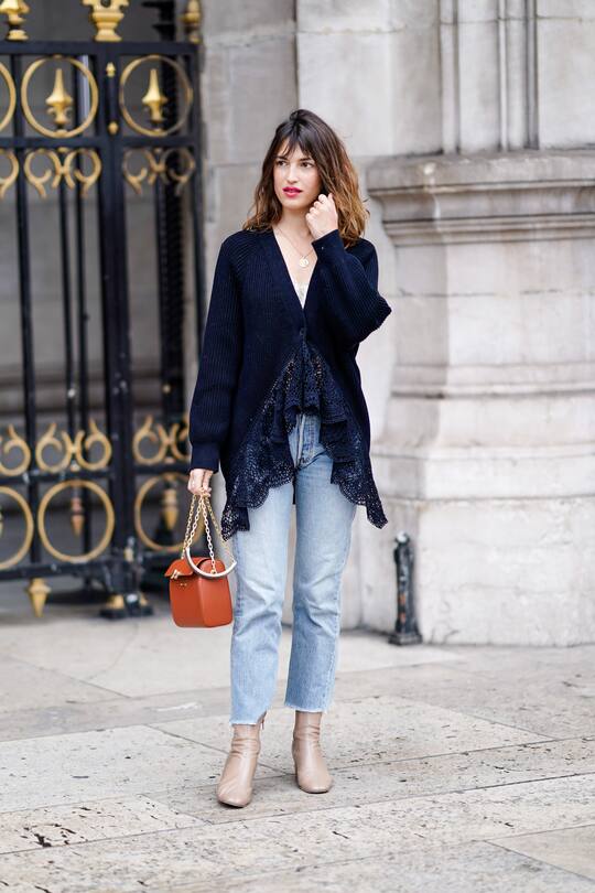 PARIS, FRANCE - MARCH 04: Jeanne Damas wears a dark blue lace wool jacket, blue jeans, an orange bag, outside Stella McCartney, during Paris Fashion Week Womenswear Fall/Winter 2019/2020, on March 04, 2019 in Paris, France. (Photo by Edward Berthelot/Getty Images)