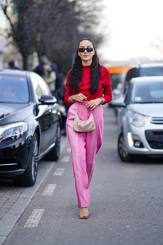 MILAN, ITALY - FEBRUARY 23: Tamara Kalinic wears sunglasses, a red top, a Prada bag, pink pants, brown shoes, outside BOSS, during Milan Fashion Week Fall/Winter 2020-2021 on February 23, 2020 in Milan, Italy. (Photo by Edward Berthelot/Getty Images)