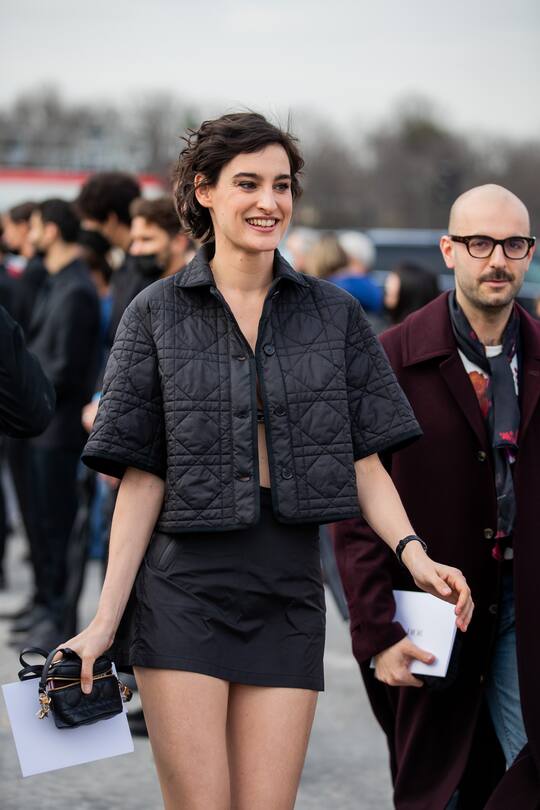 PARIS, FRANCE - MARCH 01: Nine d'Urso seen wearing Dior bar, black puffer jacket, skirt outside Dior during Paris Fashion Week - Womenswear F/W 2022-2023 on March 01, 2022 in Paris, France. (Photo by Christian Vierig/Getty Images)