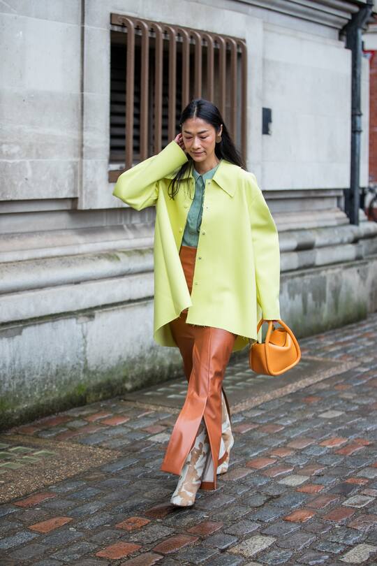 LONDON, ENGLAND - FEBRUARY 15: A guest is seen wearing neon jacket, brown pants, rust brown bag outside Molly Goddard during London Fashion Week February 2020 on February 15, 2020 in London, England. (Photo by Christian Vierig/Getty Images)