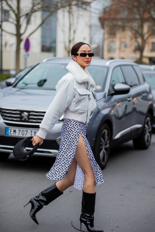 PARIS, FRANCE - MARCH 03: Chriselle Lim seen wearing skirt with slit, white shearling jacket, black mid high boots with heel, bag outside Coperni during Paris Fashion Week - Womenswear F/W 2022-2023 on March 03, 2022 in Paris, France. (Photo by Christian Vierig/Getty Images)