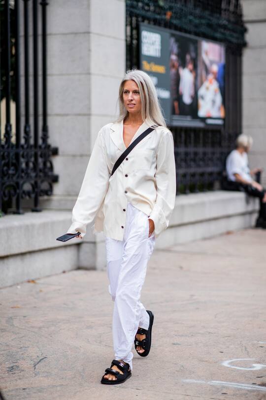 MILAN, ITALY - SEPTEMBER 21: Yoyo Cao wearing white Chanel bucket hat, cropped shorts, suit is seen outside Tods during Milan Fashion Week Spring/Summer 2019 on September 21, 2018 in Milan, Italy. (Photo by Christian Vierig/Getty Images)