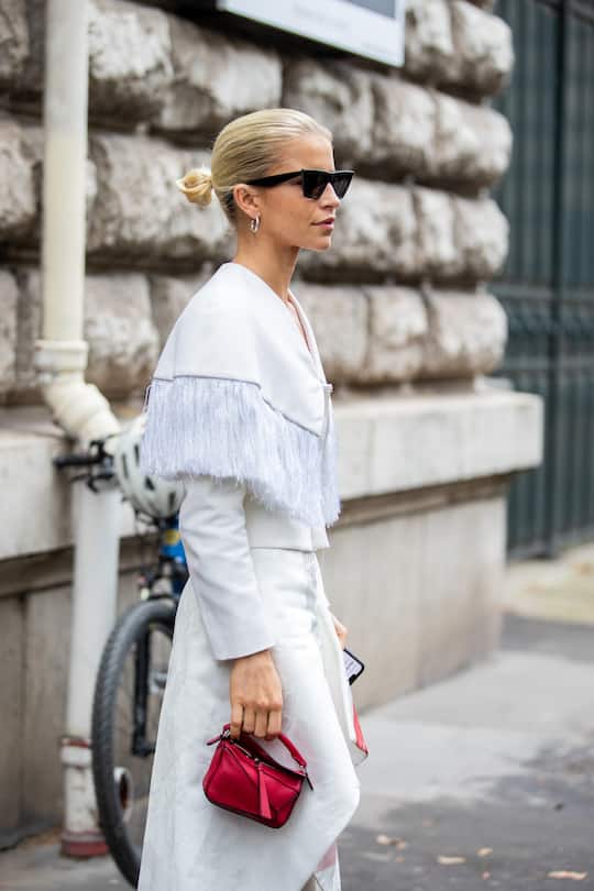 PARIS, FRANCE - OCTOBER 01: Caroline Caro Daur seen wearing red Loewe micro bag outside Loewe during Paris Fashion Week - Womenswear Spring Summer 2022 on October 01, 2021 in Paris, France. (Photo by Christian Vierig/Getty Images)