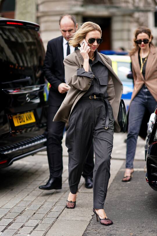 LONDON, ENGLAND - FEBRUARY 17: Lisa Aiken wears a gray jacket, a black opened shirt, a belt, large gray pants, during London Fashion Week February 2020 on February 17, 2020 in London, England. (Photo by Edward Berthelot/Getty Images)