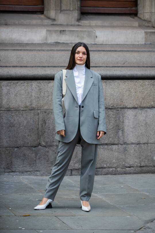 LONDON, ENGLAND - FEBRUARY 17: A guest is seen wearing grey blazer and pants, white blouse, bag outside Erdem during London Fashion Week February 2020 on February 17, 2020 in London, England. (Photo by Christian Vierig/Getty Images)