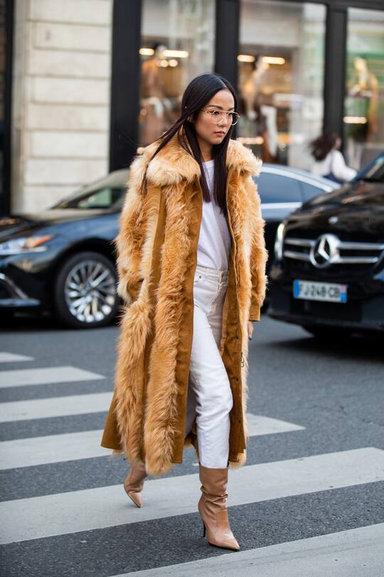 PARIS, FRANCE - SEPTEMBER 30: Yoyo Cao seen wearing beige brown fur coat, white pants, shirt, boots outside Stella McCartney during Paris Fashion Week Womenswear Spring Summer 2020 on September 30, 2019 in Paris, France. (Photo by Christian Vierig/Getty Images)