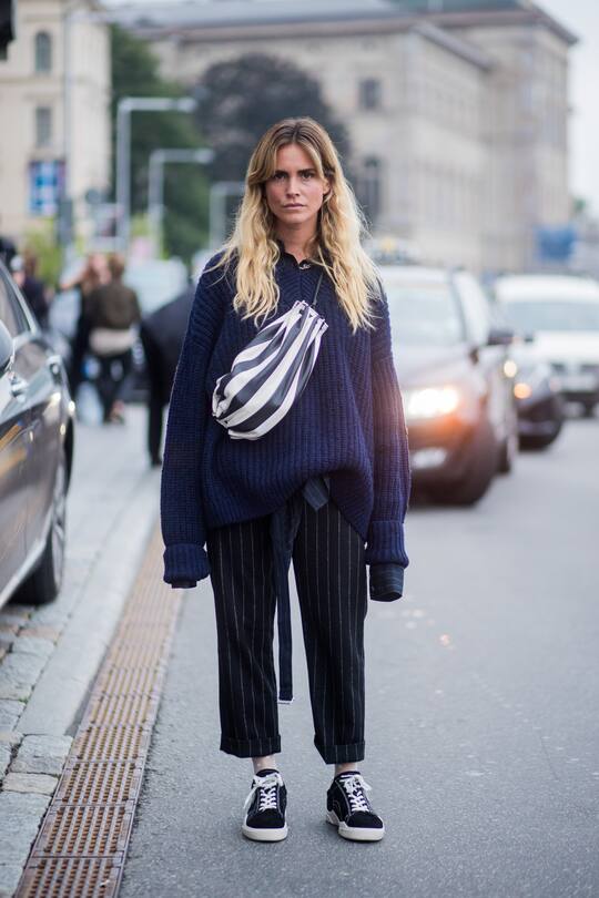 STOCKHOLM, SWEDEN - AUGUST 31: Blanca Miro Scimieri wearing a belt bag, oversized navy knit, striped pants, Vans outside House of Dagmar on August 31, 2017 in Stockholm, Sweden. (Photo by Christian Vierig/Getty Images)