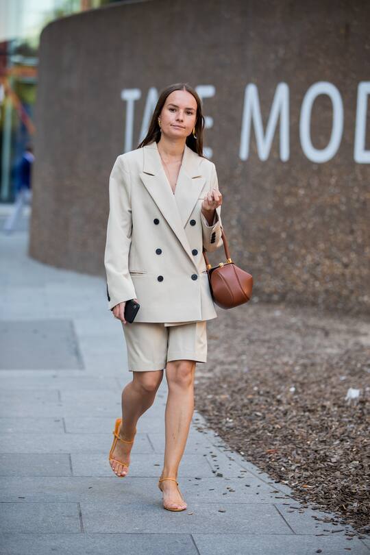 LONDON, ENGLAND - SEPTEMBER 14: A guest is seen wearing beige double breasted blazer, shorts, brown gabriela hearst bag outside Ports 1961 during London Fashion Week September 2019 on September 14, 2019 in London, England. (Photo by Christian Vierig/Getty Images)