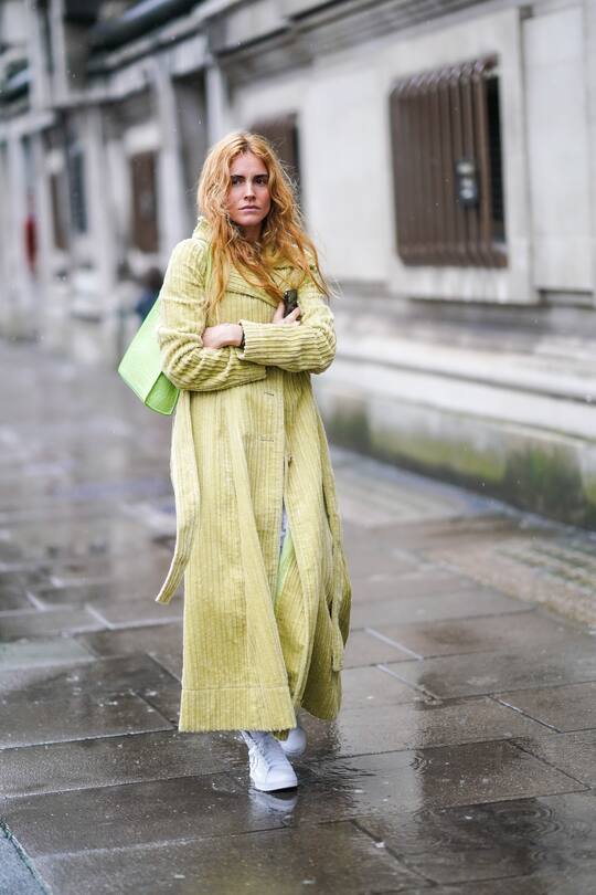 LONDON, ENGLAND - FEBRUARY 15: Blanca Miro wears a pale green corduroy long coat, a green bag with crocodile printed patterns, white sneakers, during London Fashion Week Fall Winter 2020, on February 15, 2020 in London, England. (Photo by Edward Berthelot/Getty Images)