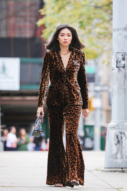 NEW YORK, NEW YORK - SEPTEMBER 09: A guest is seen wearing suede cheetah print suit and black purse in front of Spring Studios during New York Fashion Week on September 09, 2019 in New York City. (Photo by Arturo Holmes/Getty Images)