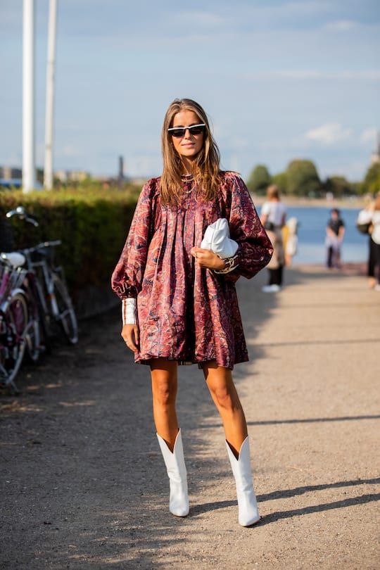 COPENHAGEN, DENMARK - AUGUST 06: Nina Sandbech is seen wearing dress with print, white bag, cowboy boots outside MUF10 during Copenhagen Fashion Week Spring/Summer 2020 on August 06, 2019 in Copenhagen, Denmark. (Photo by Christian Vierig/Getty Images)
