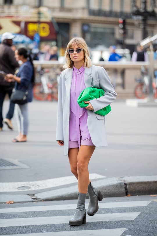 PARIS, FRANCE - SEPTEMBER 30: Xenia Adonts seen wearing green Bottega Veneta pouch bag, pink button shirt, shorts, blazer outside Stella McCartney during Paris Fashion Week Womenswear Spring Summer 2020 on September 30, 2019 in Paris, France. (Photo by Christian Vierig/Getty Images)