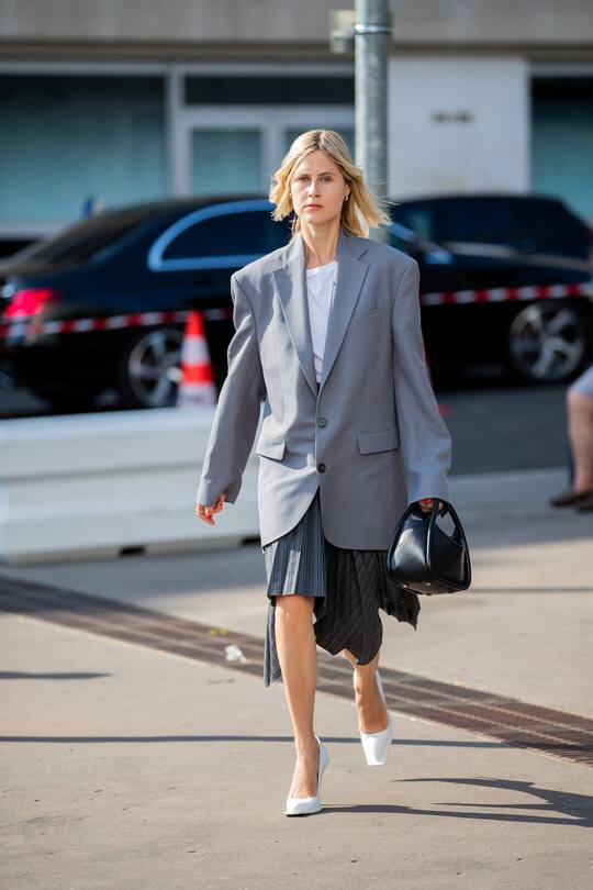 PARIS, FRANCE - JUNE 30: Linda Tol is seen wearing grey oversized blazer, black bag, asymmetric pleated skirt outside Acne during Paris Fashion Week - Haute Couture Fall/Winter 2019/2020 on June 30, 2019 in Paris, France. (Photo by Christian Vierig/Getty Images)