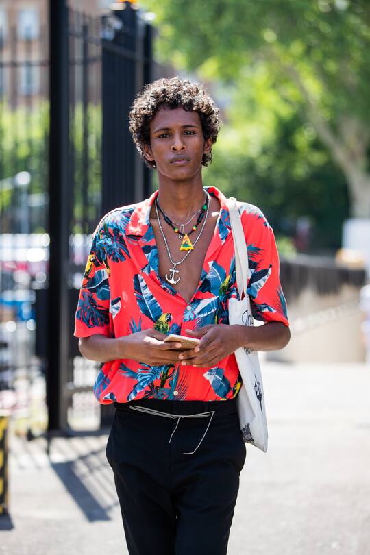 PARIS, FRANCE - JUNE 23: A model is seen wearing red button shirt with print outside Lanvin during Paris Fashion Week - Menswear Spring/Summer 2020 on June 23, 2019 in Paris, France. (Photo by Christian Vierig/Getty Images)