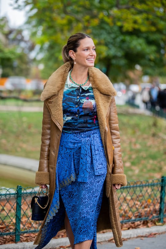 PARIS, FRANCE - SEPTEMBER 26: Helena Bordon is seen wearing brown shearling coat, blue asymmetric skirt, top with print outside Chloe during Paris Fashion Week Womenswear Spring Summer 2020 on September 26, 2019 in Paris, France. (Photo by Christian Vierig/Getty Images)