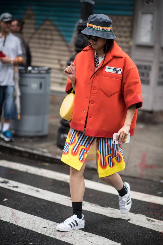 MILAN, ITALY - SEPTEMBER 21: Yoyo Cao wearing white Chanel bucket hat, cropped shorts, suit is seen outside Tods during Milan Fashion Week Spring/Summer 2019 on September 21, 2018 in Milan, Italy. (Photo by Christian Vierig/Getty Images)