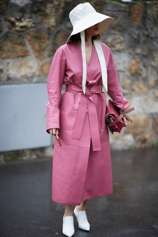 PARIS, FRANCE - FEBRUARY 27: Erika Boldrin (R) wears a turtleneck, a grey jacket with apparent white seams, a purple puff bag ; Blanca Miro (L) wears a black hat, a grey sleeveless vest, grey pants, a red puff bag, outside Maison Margiela, during Paris Fashion Week Womenswear Fall/Winter 2019/2020, on February 27, 2019 in Paris, France. (Photo by Edward Berthelot/Getty Images)