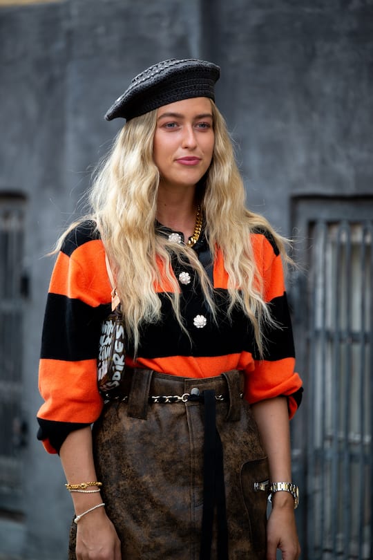 COPENHAGEN, DENMARK - AUGUST 10: Emili Sindlev outside Ganni wearing brown leather skirt, orange and black sweater and beret during Copenhagen fashion week SS21 on August 10, 2020 in Copenhagen, Denmark. (Photo by Raimonda Kulikauskiene/Getty Images)