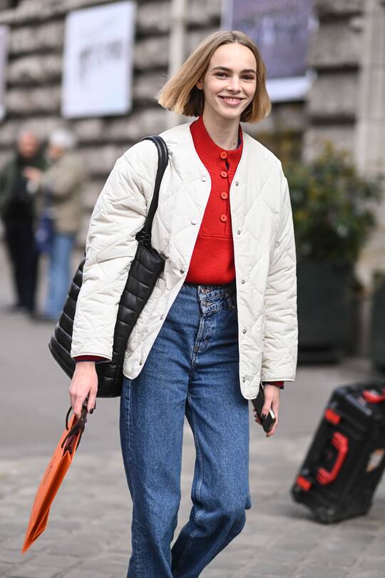 PARIS, FRANCE - MARCH 05: Model Puck Schrover is seen wearing a white jacket, red sweater and blue jeans outside the Hermes show during Paris Fashion Week A/W 2022 on March 05, 2022 in Paris, France. (Photo by Daniel Zuchnik/Getty Images)