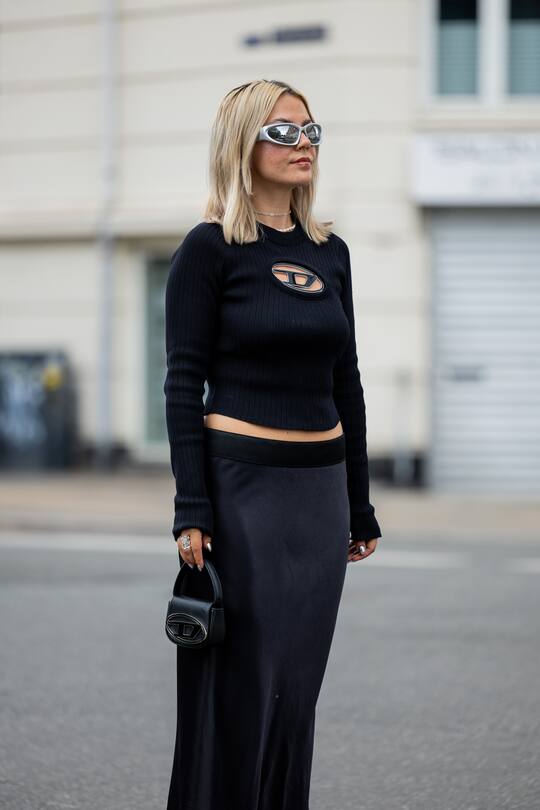 COPENHAGEN, DENMARK - AUGUST 08: Amelie Stanescu is seen wearing black vintage skirt, diesel bag, diesel knit top, balenciaga sunglasses, Givenchy shoes on August 08, 2022 in Copenhagen, Denmark. (Photo by Christian Vierig/Getty Images)