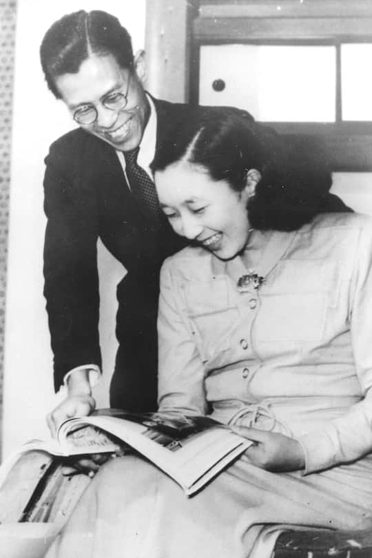 Princess Kazuko, aka Princess Taka (1929 - 1989), daughter of Japanese Emperor Hirohito, shares a laugh with her fiance, Toshimichi Takatsukasa (1923 - 1966), as they look at a magazine in the Imperial Palace, Tokyo, Japan, March 9, 1950. The couple married two months later, on May 21. (Photo by PhotoQuest/Getty Images)