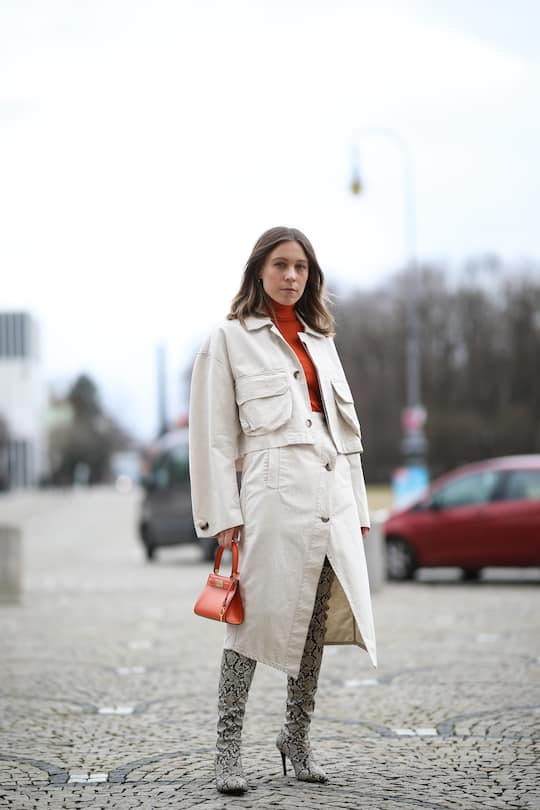 MUNICH, GERMANY - FEBRUARY 14: Sarah Schäfer wearing Tory Burch bag, Baum & Pferdgarten skirt and jacket, orange Max & Co turtleneck and Mango overknees on February 14, 2020 in Munich, Germany. (Photo by Jeremy Moeller/Getty Images)