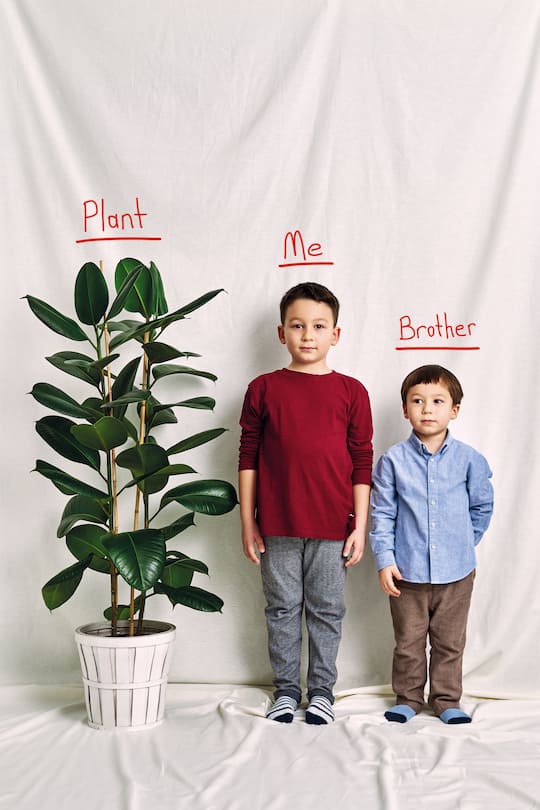 Cute child measuring his height. Growth and competition concept.