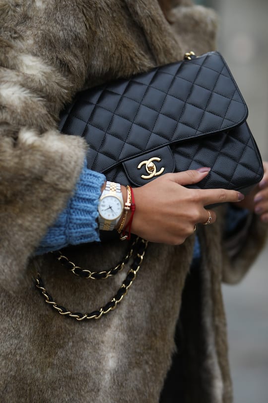 BERLIN, GERMANY - DECEMBER 12: Laura Noltemeyer wearing H&M Fake Fur coat and H&M sweater, Chanel bag, Rayban sunglasses and Zara boots on December 12, 2019 in Berlin, Germany. (Photo by Jeremy Moeller/Getty Images)