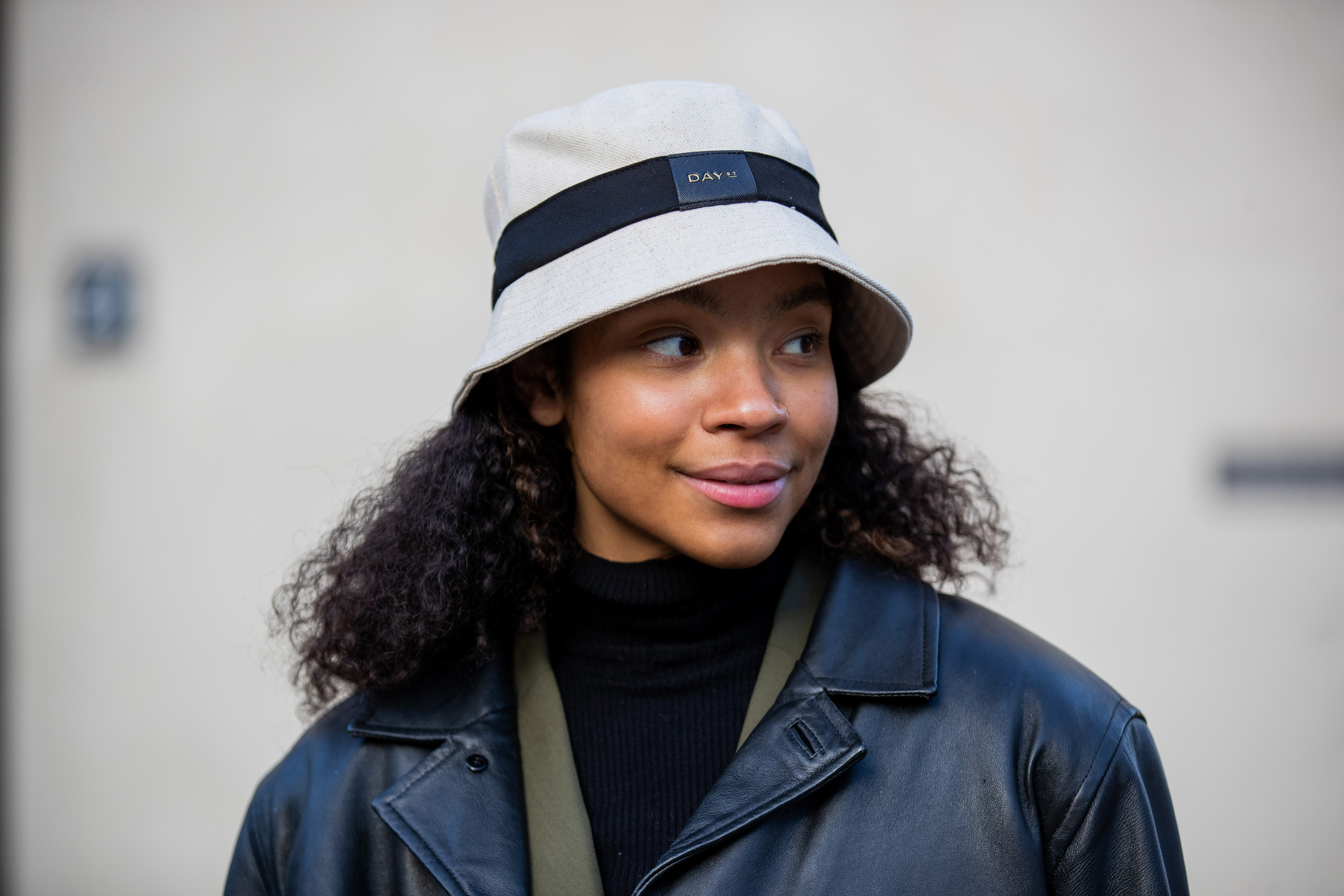 COPENHAGEN, DENMARK - FEBRUARY 01: Sara Flaaen Licius wearing two tone jacket, green pants, bag & hat DAY Et, black boots during Copenhagen Fashion Week Autumn/Winter 2022 on February 01, 2022 in Copenhagen, Denmark. (Photo by Christian Vierig/Getty Images)